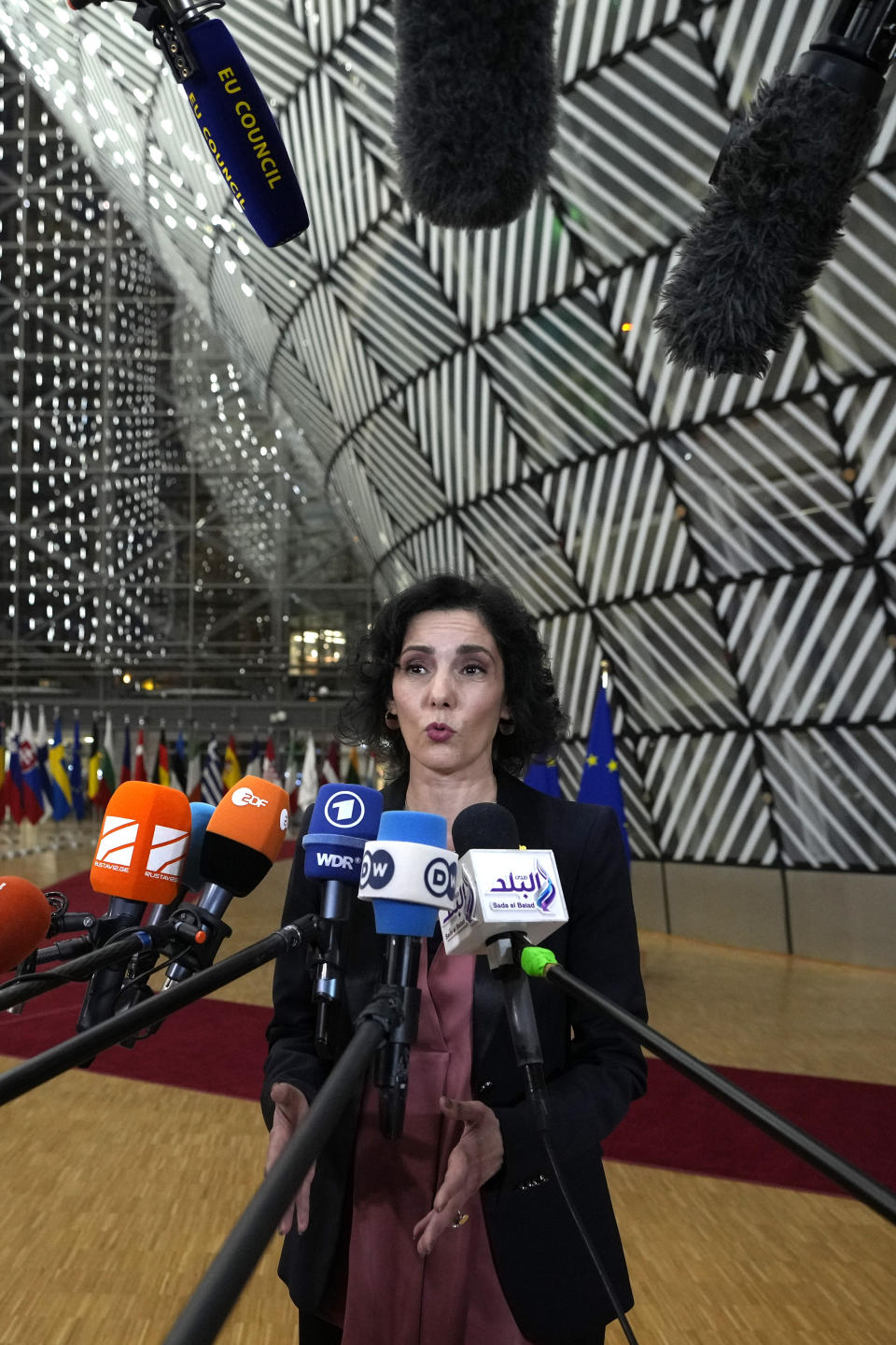 Belgium's Foreign Minister Hadja Lahbib speaks with the media as she arrives for a meeting of EU foreign ministers at the European Council building in Brussels, Monday, Jan. 22, 2024. European Union Foreign Affairs Ministers meet in Brussels on Monday to discuss the situation in the Middle East and in Ukraine. (AP Photo/Virginia Mayo)