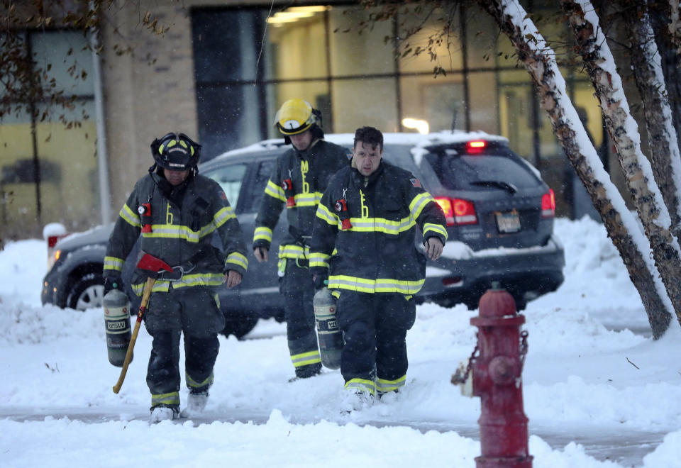 Minneapolis firefighters leave high-rise apartment building after a deadly fire Wednesday, Nov. 27, 2019, in Minneapolis. (David Joles/Star Tribune via AP)