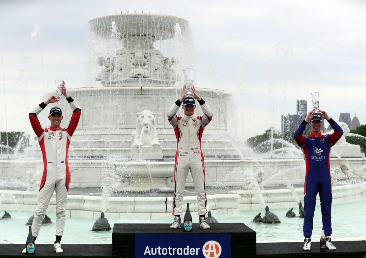 Winners of the Indy Lights Championship celebrate raise their trophies in front of the James Scott Memorial Fountain on Sunday, June 5, 2022, on Belle Isle.