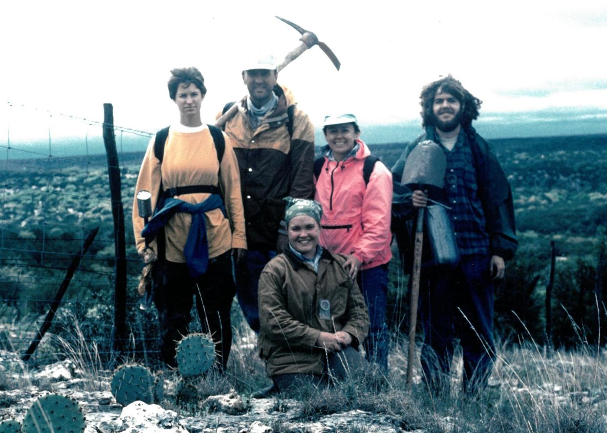 Texas archaeologist Margaret Howard (pink jacket) with a team surveying the Devil's Sinkhole in 1995.