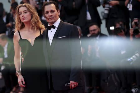 Actor Johnny Depp and his wife Amber Heard attend the red carpet event for the movie "Black Mass" at the 72nd Venice Film Festival in northern Italy September 4, 2015. REUTERS/Manuel Silvestri