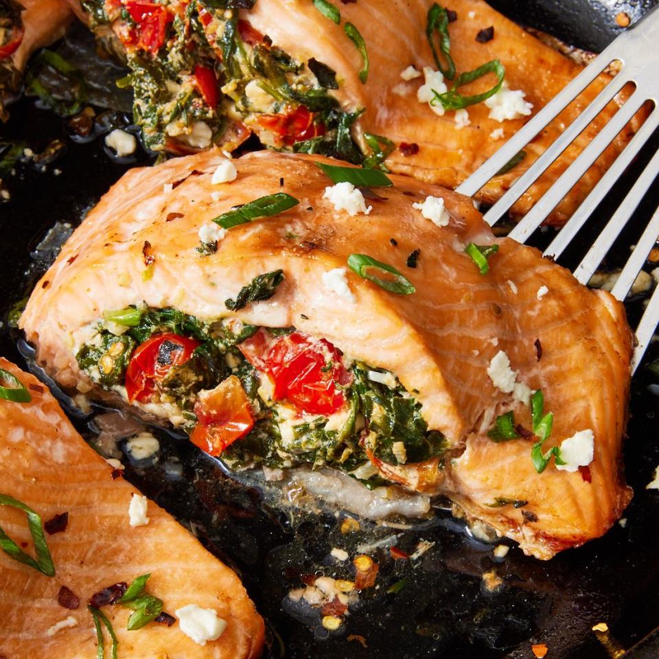 roasted salmon fillet stuffed with feta, spinach, and tomato and topped with crushed red pepper and scallions