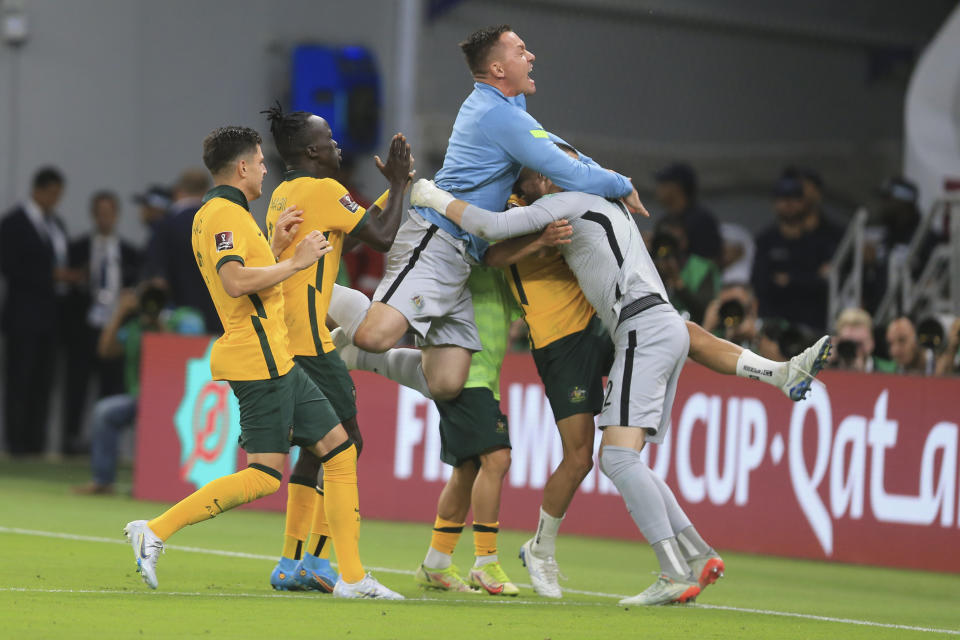 Los jugadores de Australia festejan la victoria 5-4 sobre Perú por penales en el repechaje intercontinental por una plaza a la Copa Mundial, en Al Rayyan, Qatar, el lunes 13 de junio de 2022. (AP Foto/Hussein Sayed)