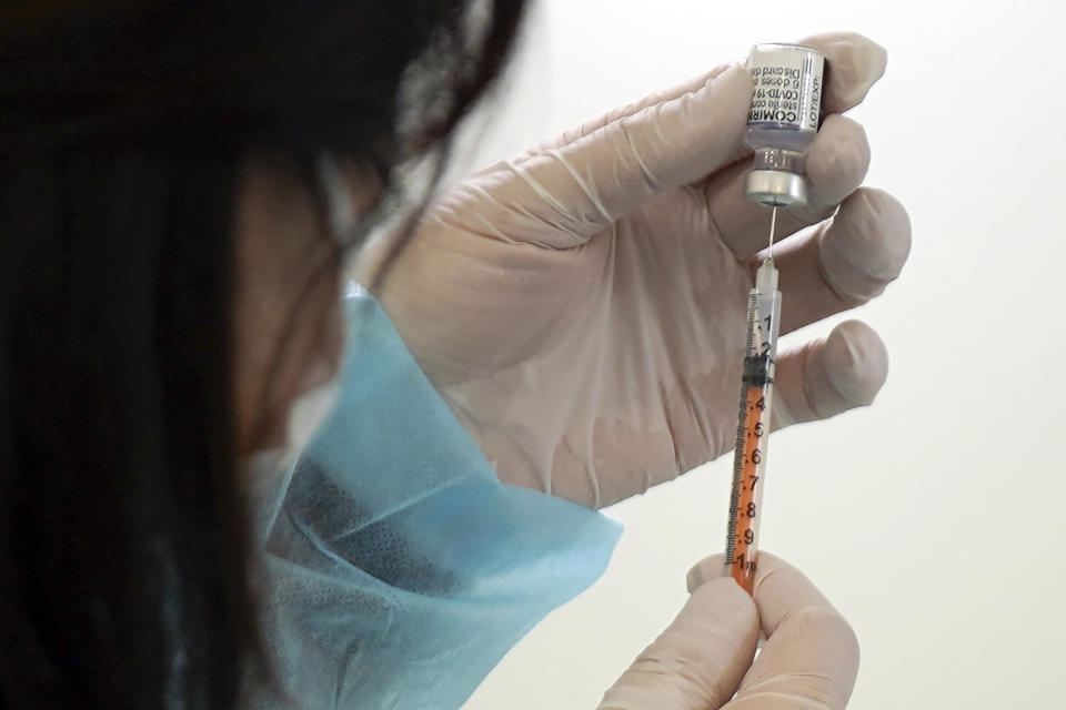 FILE - A health worker prepares a dose of the Pfizer COVID-19 vaccine in the complex of the Tokyo Skytree, Thursday, Jan. 6, 2022, in Sumida ward of Tokyo. On Friday, Sept. 6, 2023 The Associated Press reported on stories circulating online incorrectly claiming Japan stopped mandatory childhood vaccinations in 1994, vastly improving the country’s infant mortality rate. (AP Photo/Eugene Hoshiko, FILE)