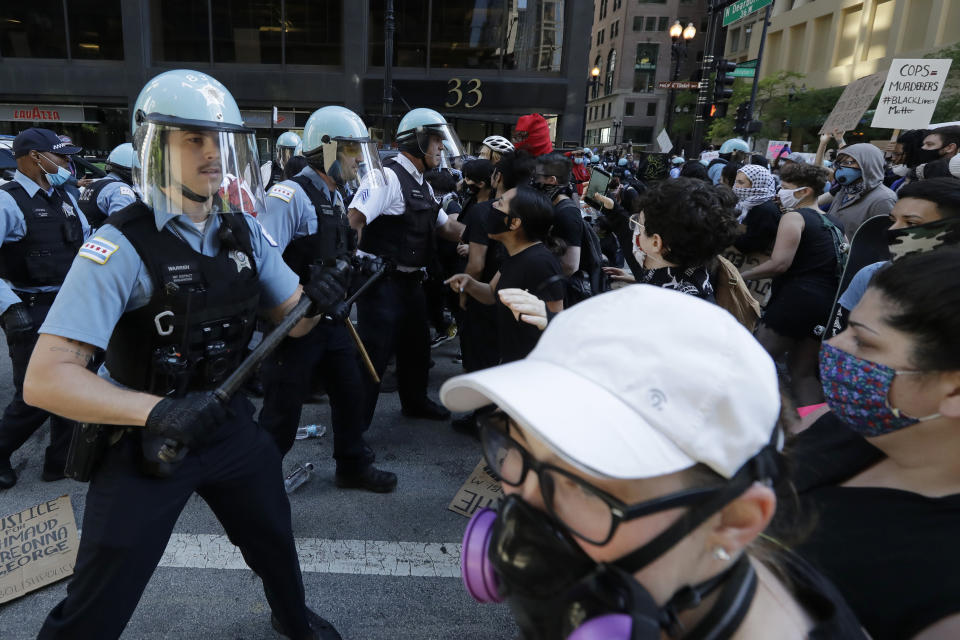 Chicago Police officers and protesters clash during a protest over the death of George Floyd in Chicago, Saturday, May 30, 2020. Floyd died after being taken into custody and restrained by Minneapolis police on Memorial Day in Minnesota. (AP Photo/Nam Y. Huh)