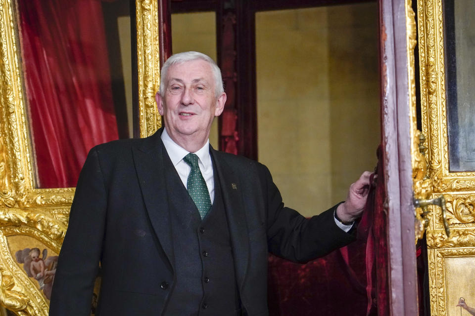 Britain's Speaker of the House of Commons Lindsay Hoyle stands next to the Speaker's State Coach as it returns to Westminster, ahead of the coronation of Britain's King Charles III, in London, Sunday, April 30, 2023. The gilded coach, which was last seen in the historic Westminster Hall in 2005, will be on display once again from 2 May to the Autumn, to commemorate the crowning of King Charles III. (AP Photo/Alberto Pezzali)