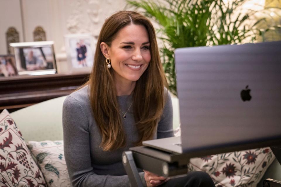 In this photo released by Kensington Palace on Wednesday, Jan. 27, 2021, Duchess Kate of Cambridge smiles during a video call with Holocaust survivors and youth ambassadors from the Holocaust Educational Trust to mark Holocaust Memorial Day.