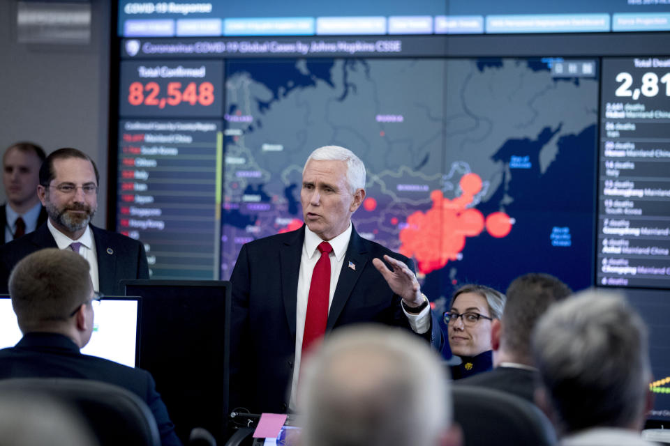 A large monitor displaying a map of Asia and a tally of total coronavirus cases, deaths, and recovered, is visible behind Vice President Mike Pence, center, and Health and Human Services Secretary Alex Azar, left, as they tour the Secretary's Operations Center following a coronavirus task force meeting at the Department of Health and Human Services Feb. 27 in Washington. (Photo: Andrew Harnik/AP)