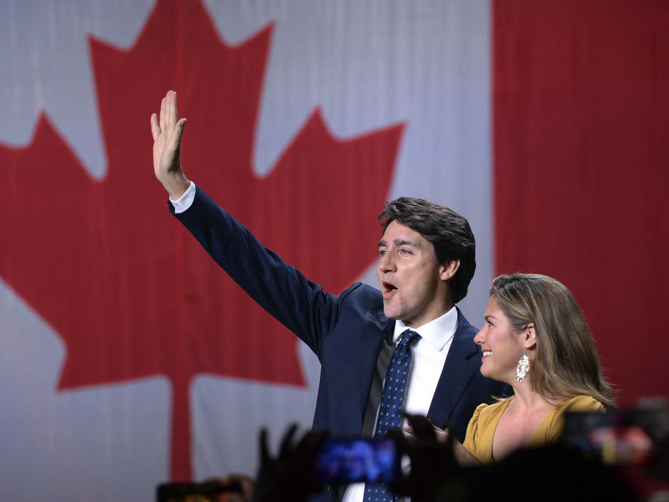 Liberal leader Justin Trudeau and wife Sophie Gregoire Trudeau wave as they go on stage at Liberal election headquarters in Montreal, Monday, Oct. 21, 2019. (Ryan Remiorz/The Canadian Press via AP)