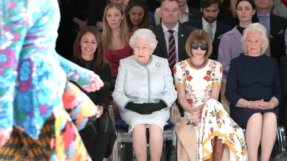 Queen Elizabeth II sits with Anna Wintour, Caroline Rush (L), chief executive of the British Fashion Council (BFC) and royal dressmaker Angela Kelly (R) as they view Richard Quinn's runway show