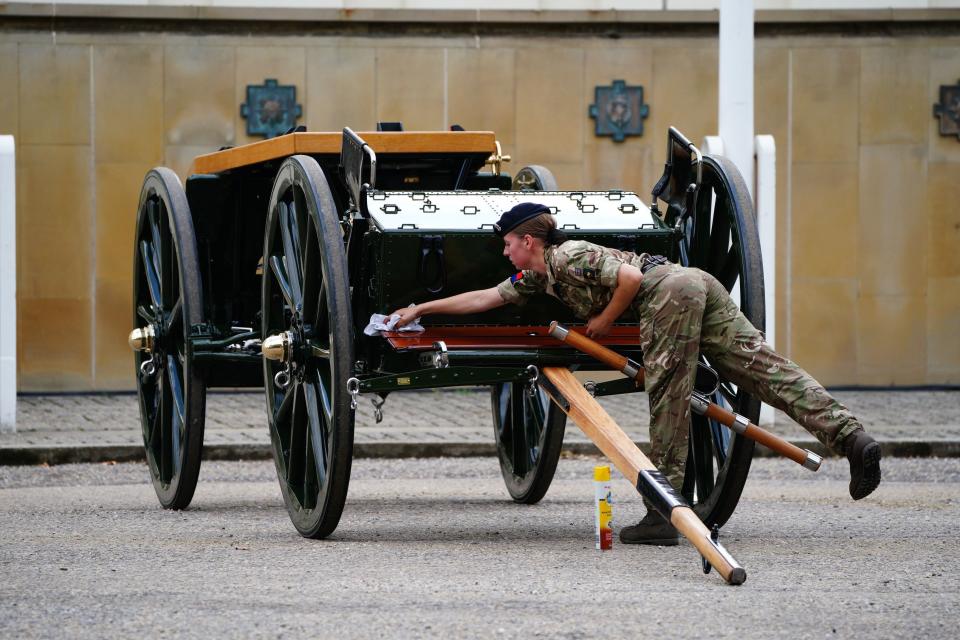 Military personnel clean a gun carriage as they make their final preparations at Wellington Barracks, central London, ahead of the ceremonial procession of the coffin of Queen Elizabeth II (PA)