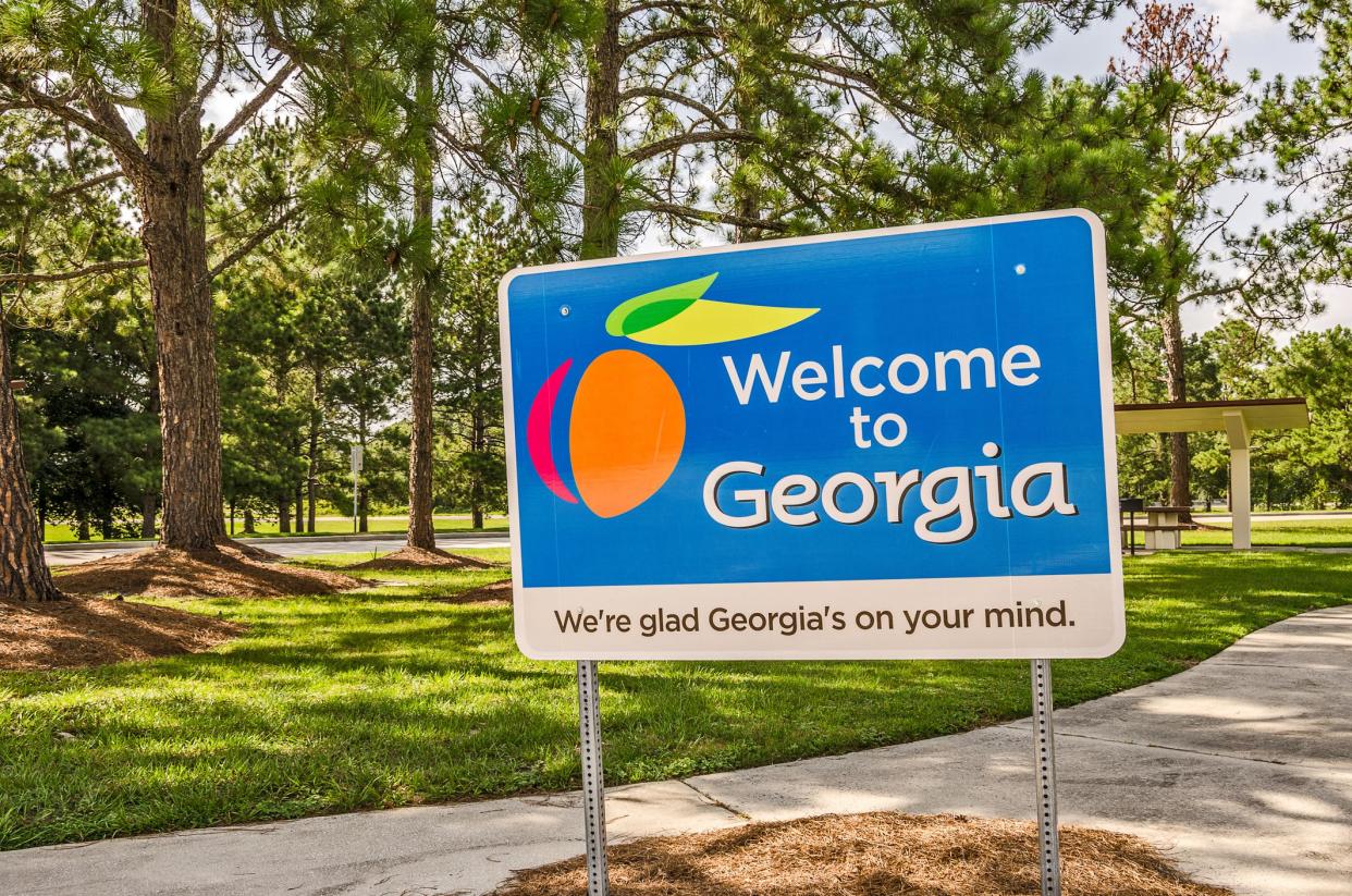 State sign for Georgia welcomes visitors in a shaded rest area