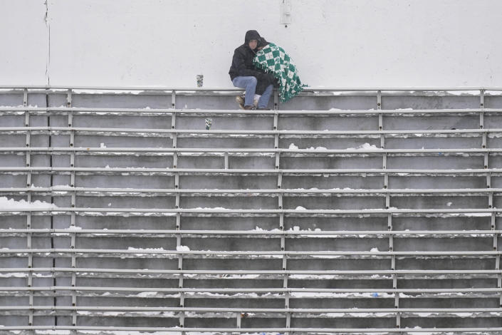 A couple sits in the upper deck of Spartan Stadium during the second half of an NCAA college football game between Michigan State and Indiana, Saturday, Nov. 19, 2022, in East Lansing, Mich. (AP Photo/Carlos Osorio)