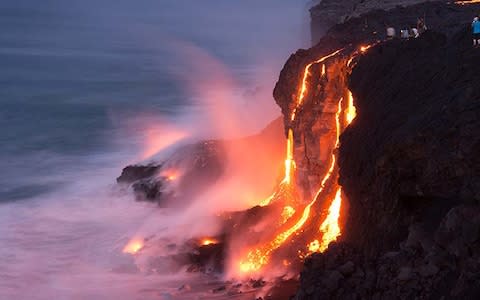 Lava flows from the volcano on Hawaii's east side flow directly into the sea - Credit: Getty