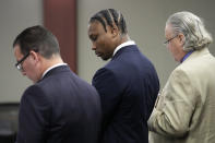 Former Las Vegas Raiders player Henry Ruggs, center, appears in court Wednesday, May 10, 2023, in Las Vegas. Ruggs plead guilty to driving his car drunk before causing a fiery crash that killed a woman. (AP Photo/John Locher)