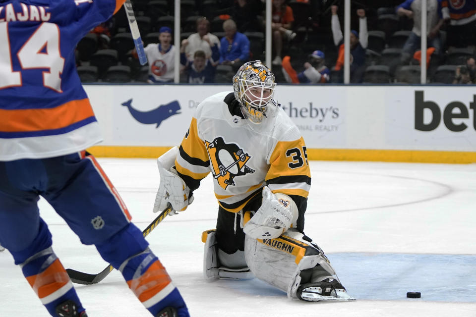 Pittsburgh Penguins goaltender Tristan Jarry (35) reacts as he looks at the puck shot by New York Islanders' Ryan Pulock for a goal during the second period of Game 6 of an NHL hockey Stanley Cup first-round playoff series, Wednesday, May 26, 2021, in Uniondale, N.Y. (AP Photo/Frank Franklin II)