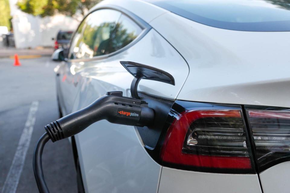 A Tesla charges at the Chargepoint space in Forsyth Park.