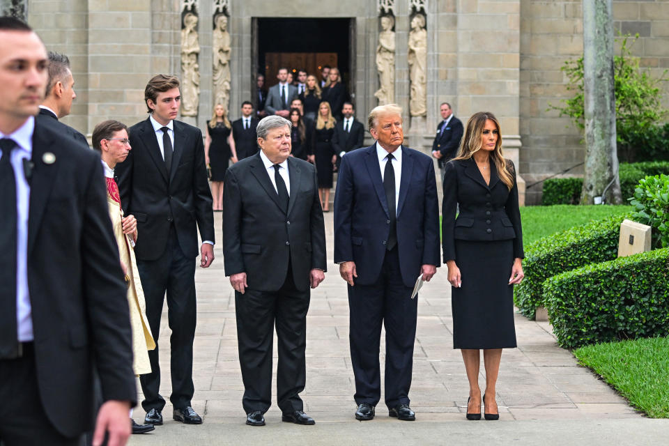 Former US President Donald Trump (2R) stands with his wife Melania Trump (R) their son Barron Trump (4L) and father-in-law Viktor Knavs (C), as they depart a funeral for Amalija Knavs, the former first lady's mother, outside the Church of Bethesda-by-the-Sea, in Palm Beach, Florida, on January 18, 2024. Former first lady Melania Trump's mother Amalija Knavs, 78, died January 9, 2024 in Miami following an undisclosed illness. (Photo by GIORGIO VIERA / AFP) (Photo by GIORGIO VIERA/AFP via Getty Images)