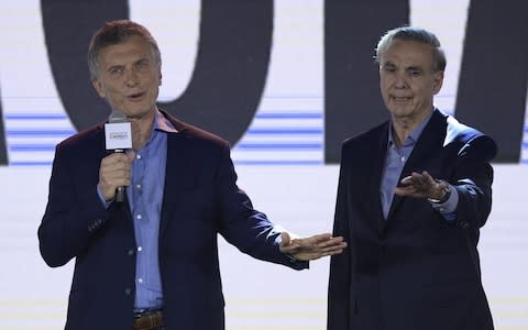 Argentina's President Mauricio Macri (L), presidential candidate of "Juntos por el Cambio" party, next to his ticket partner Miguel Angel Pichetto  - Credit: AFP