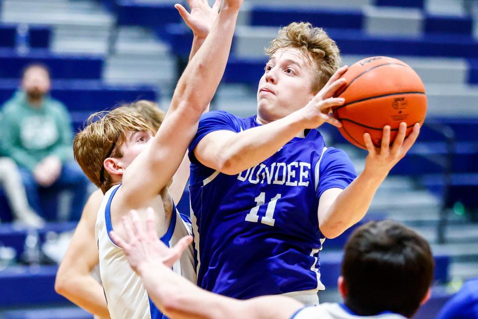 Dundee's Ethan Layton takes the ball inside against Ida during a 46-40 Dundee victory in the finals of the Division 2 District at Airport on Friday, March 1, 2024.