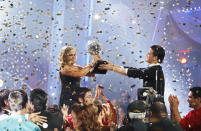 Johnson holds up the mirror ball trophy with partner Mark Ballas after her "Dancing" win.