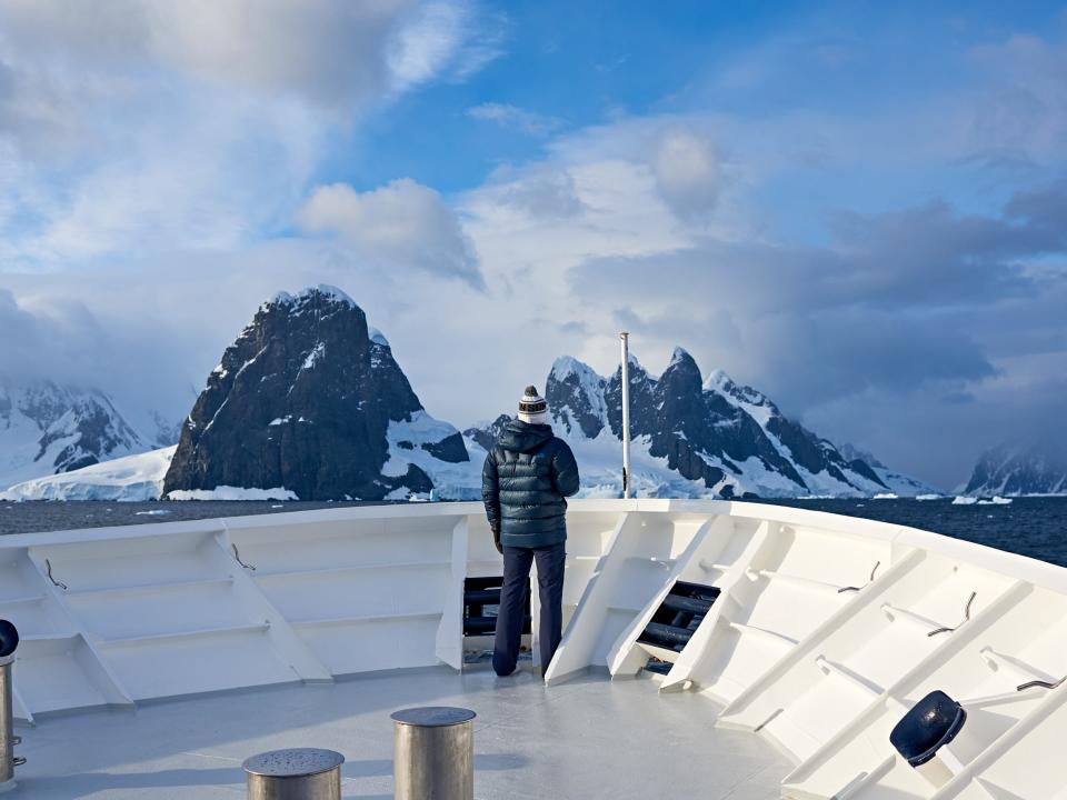 An EYOS ship in Arctic tundra. Someone is standing on the ship