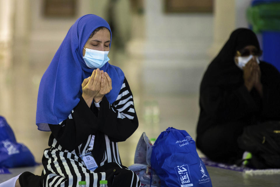 In this photo released by the Saudi Media Ministry, a limited numbers of pilgrims pray in the first rituals of the hajj, as they keep social distancing to limit exposure and the potential transmission of the coronavirus, at the Grand Mosque in the Muslim holy city of Mecca, Saudi Arabia, Wednesday, July 29, 2020. A unique and scaled-down hajj started on Wednesday. (Saudi Media Ministry via AP)