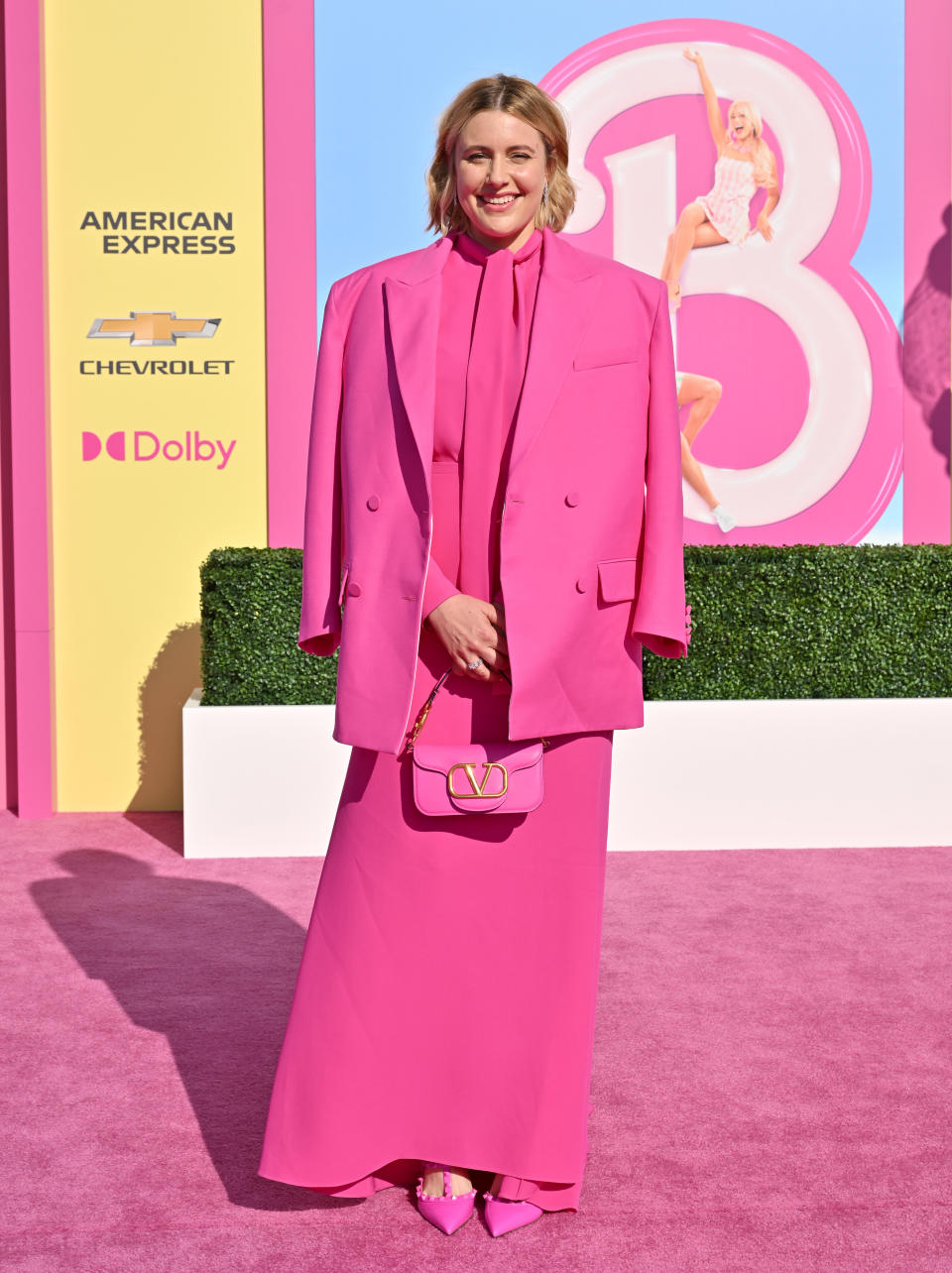 Greta rocking Barbie pink on the pink the carpet for the premiere of her film