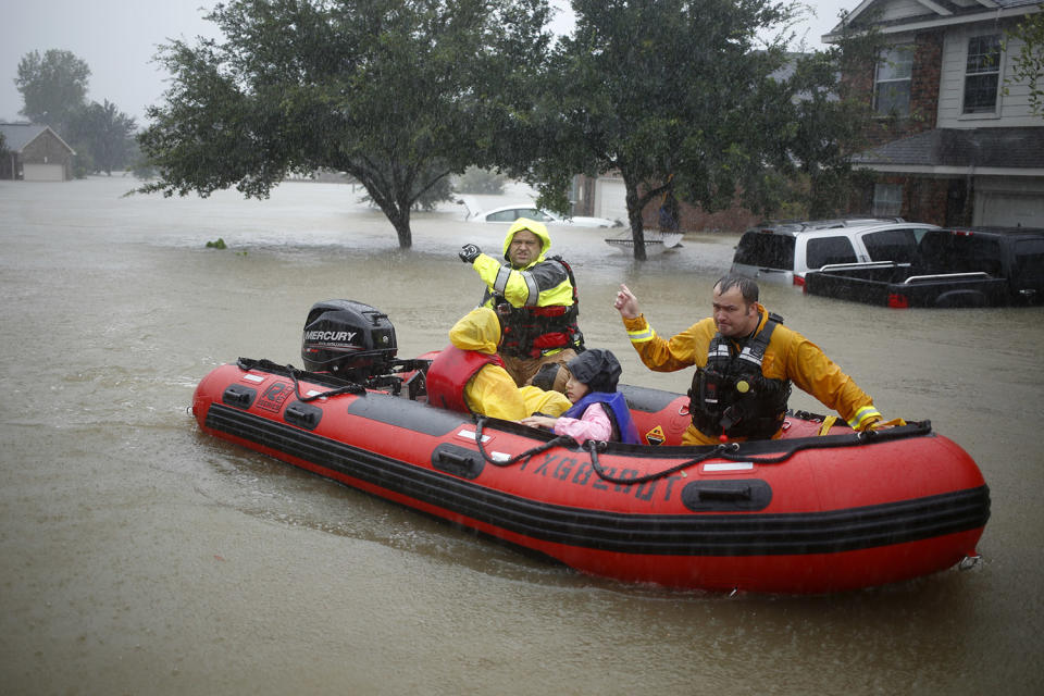 Rescuers help trapped residents escape from rising floodwaters in Spring, Texas, on Monday. (Photo: Luke Sharrett/Bloomberg via Getty Images)