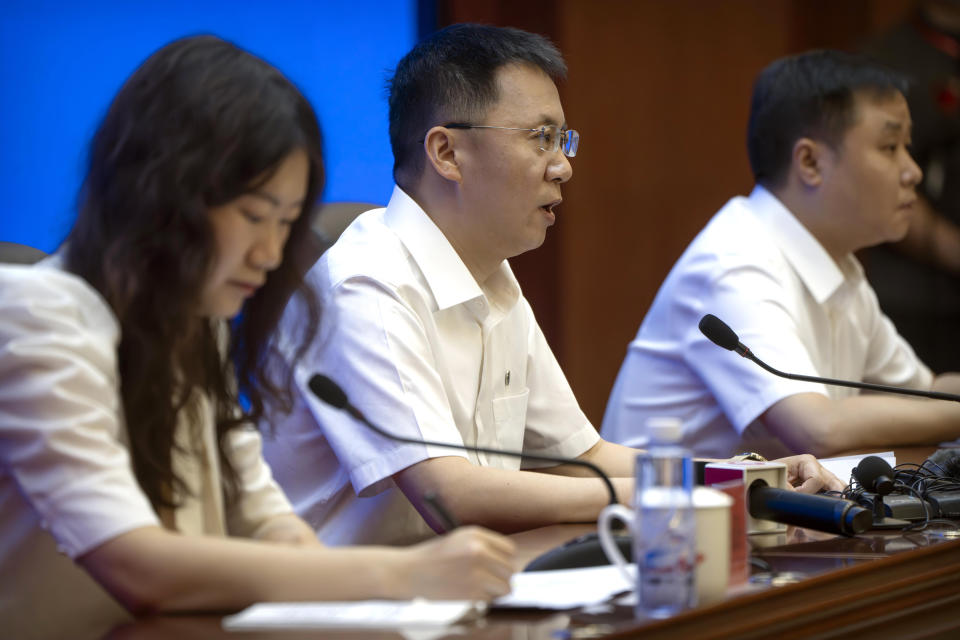 Lin Xiqiang, Deputy Director of the Chinese Manned Space Agency, center, speaks during a press conference at the Jiuquan Satellite Launch Center in northwest China on Monday, May 29, 2023. China's space program plans to land astronauts on the moon before 2030, a top official with the country's space program said Monday. (AP Photo/Mark Schiefelbein)