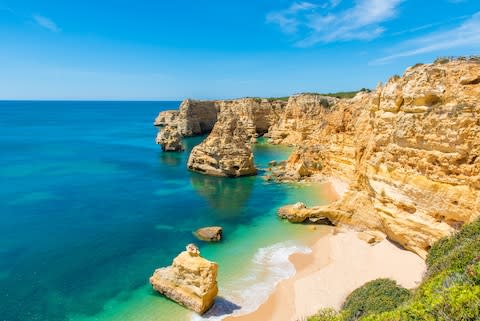 Britons are choosing to bring their children to the beaches of the Canaries or the Algarve (above) before booking a seaside staycation - Credit: SIMON DANNHAUER