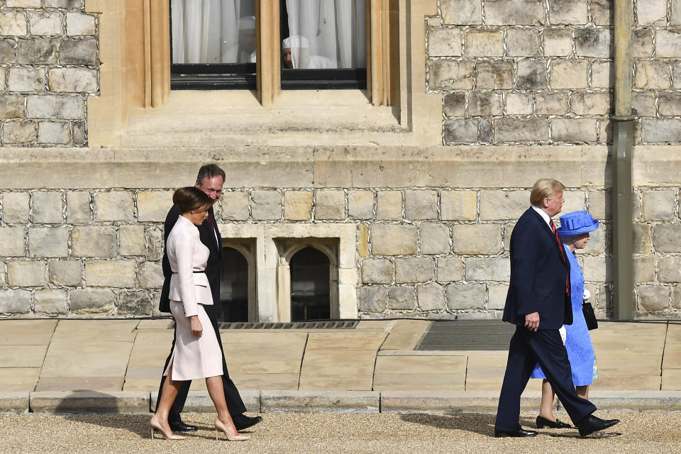 Britain’s Queen Elizabeth II, right, walks with US President Donald Trump as first lady Melania is escorted in the Quadrangle at Windsor Castle, Friday, July 13, 2018 in Windsor, England. The monarch welcomed the American president in the courtyard of the royal castle. (Ben Stansall/Pool Photo via AP)