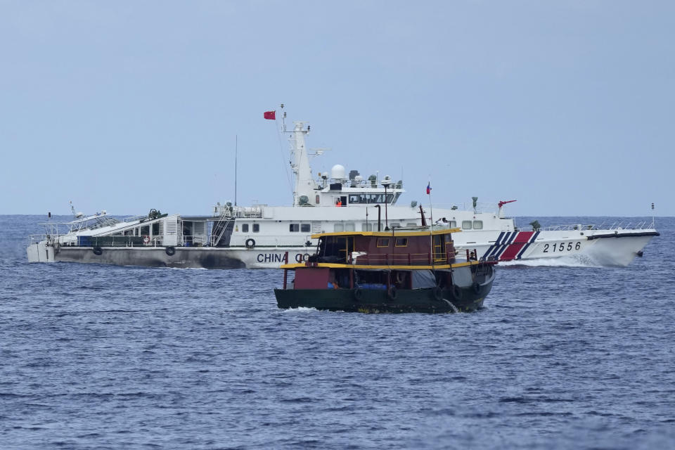 A Philippine supply boat manuevers as a Chinese coast guard tries to block it's way as it heads towards Second Thomas Shoal, locally known as Ayungin Shoal, at the disputed South China Sea on Tuesday, Aug. 22, 2023. As a U.S. Navy plane circled overhead, two Philippine navy-manned boats manage to breach through a Chinese coast guard blockade in a dangerous confrontation in the disputed South China Sea and succeeded in delivering food and other supplies to Filipino forces guarding a contested shoal on board BRP Sierra Madre. (AP Photo/Aaron Favila)