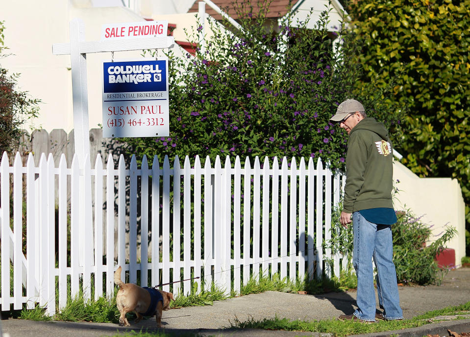 A man walks his dog by a 