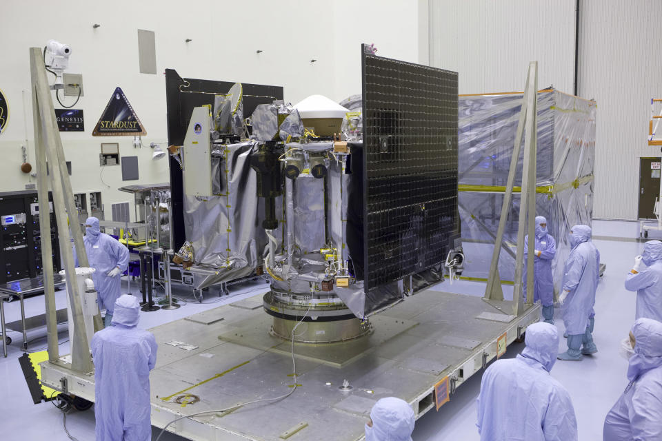 FILE - This May 21, 2016, file photo provided by NASA shows the Osiris-Rex spacecraft inside a servicing facility at Kennedy Space Center in Florida after arriving from Lockheed Martin's facility near Denver. The Osiris-Rex spacecraft entered orbit Monday, Dec. 31, 2018, around the asteroid Bennu, 70 million miles (110 million kilometers) from Earth. It’s the smallest celestial body ever to be orbited by a spacecraft. Bennu is just 1,600 feet (500 meters) across. (Dimitri Gerondidakis/NASA via AP, File)