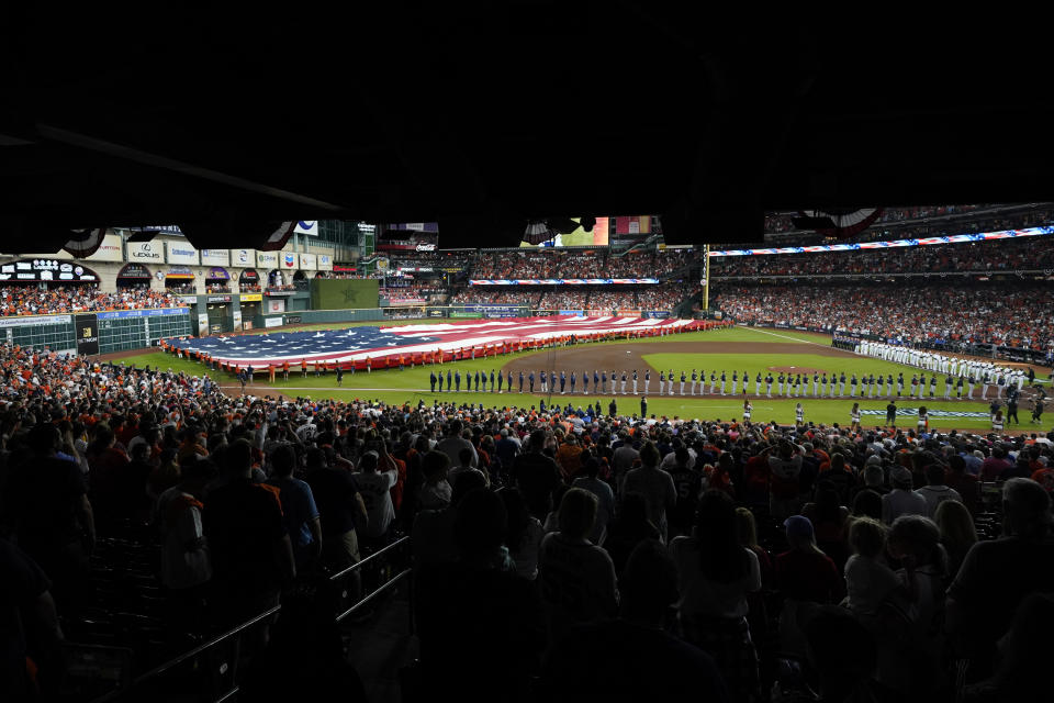 Players line up before Game 1 in baseball's World Series between the Houston Astros and the Atlanta Braves Tuesday, Oct. 26, 2021, in Houston. (AP Photo/Eric Gay)