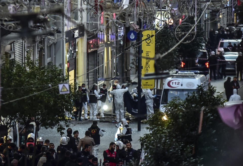 FILE - Forensic experts collect a dead body after an explosion on Istanbul's popular pedestrian Istiklal Avenue Sunday, Istanbul, Sunday, Nov. 13, 2022. (Ismail Coskun/IHA via AP, File)