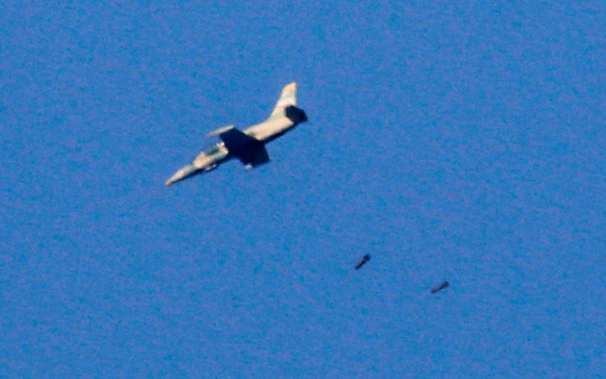 A warplane drops bombs on the southwestern Syrian province of Daraa in 2018 - AFP