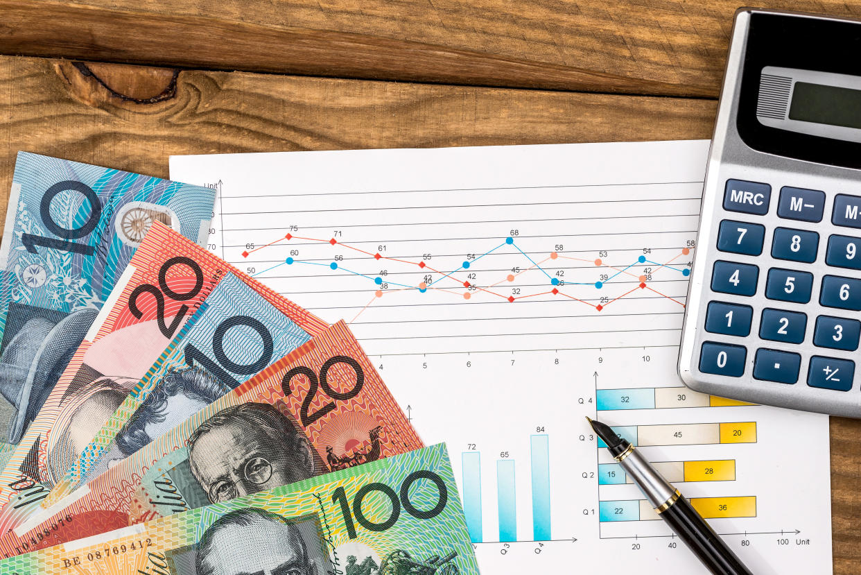 australian dollar with graph calculator on table