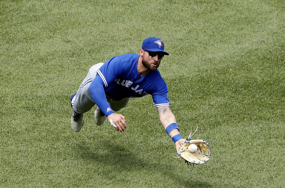 Kevin Pillar makes a diving catch on Boston Red Sox’s Brock Holt. (AP Photo/Winslow Townson)