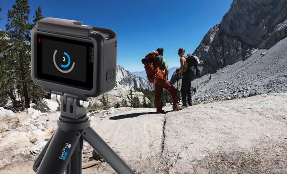 A GoPro Hero 7 Black pointed at two hikers.