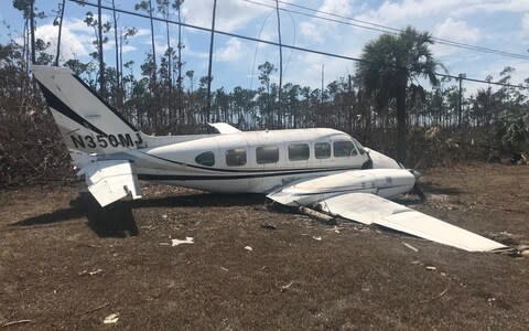 A plane thrown by the storm on the side of the road near Freetown airport - Credit: Hayley Dixon for the Telegraph