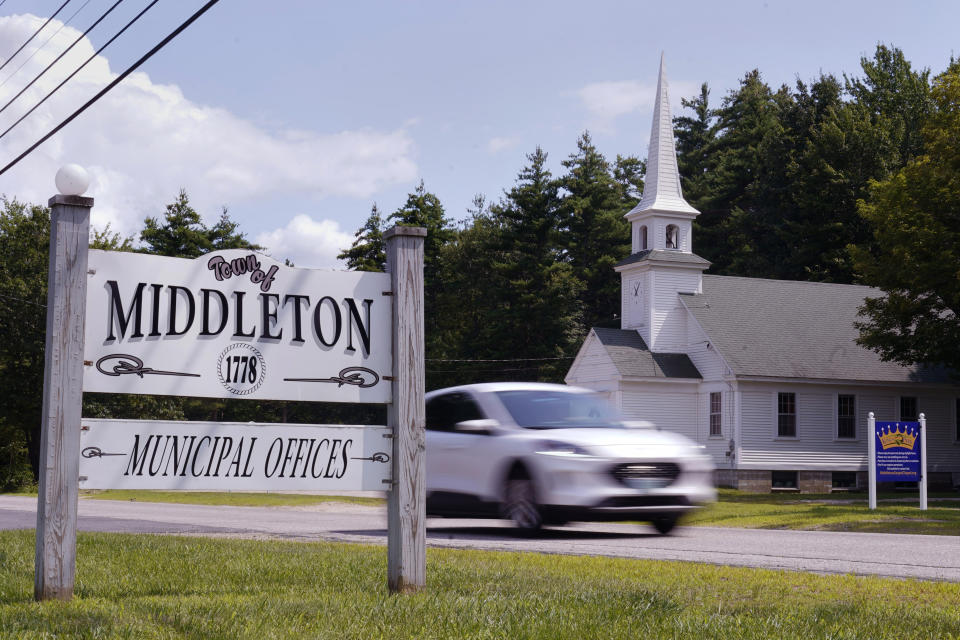 A car passes a sign outside the Middleton, N.H. municipal offices and Middleton Gospel Chapel, near a Dorsainvil family home, Monday, July 31, 2023, in Middleton. Alix Dorsainvil, a nurse for El Roi Haiti, and her daughter were kidnapped on Thursday, the organization said in a statement Saturday. El Roi, which runs a school and ministry in Port au Prince, said the two were taken from campus. (AP Photo/Charles Krupa)