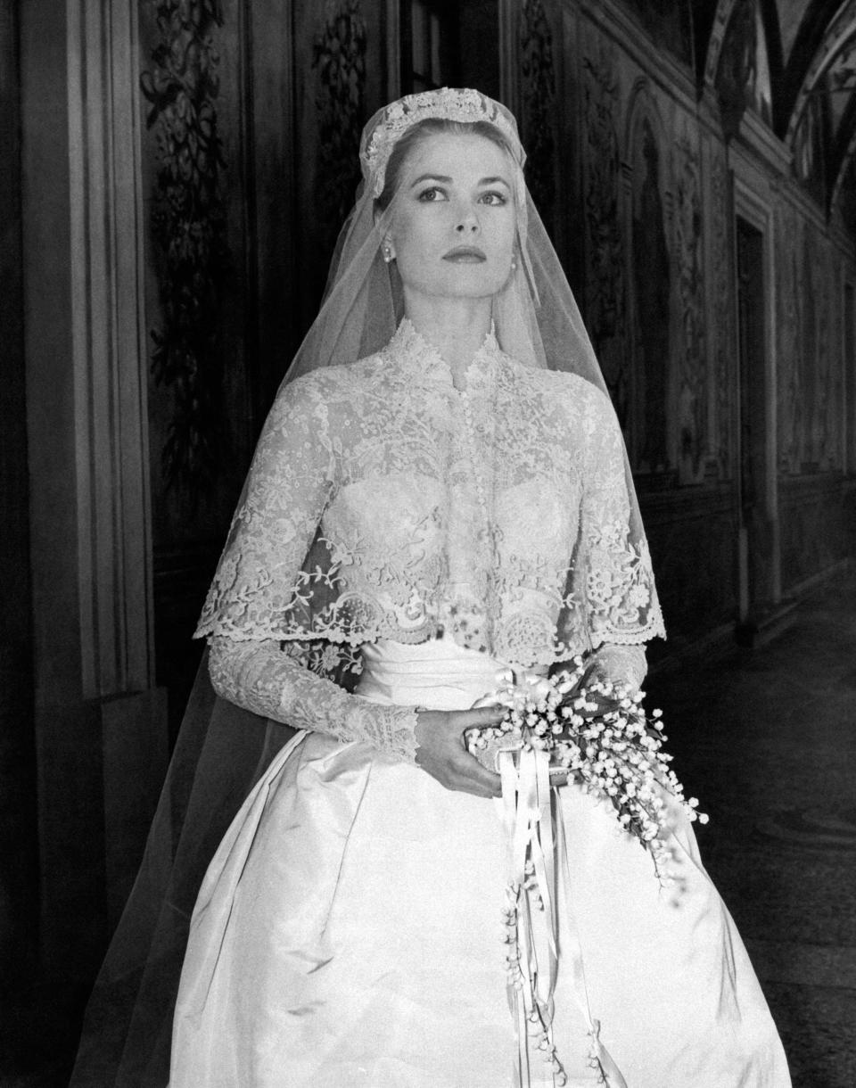 grace kelly wedding dress, Photo of the great movie star Grace Kelly in her wedding dress in a frescoed gallery inside the Prince's Palace, just before the wedding ceremony where she will marry Ranier III of Monaco, being a princess of the Principality.  Monaco, April 18, 1956. (Photo by Mondadori via Getty Images)