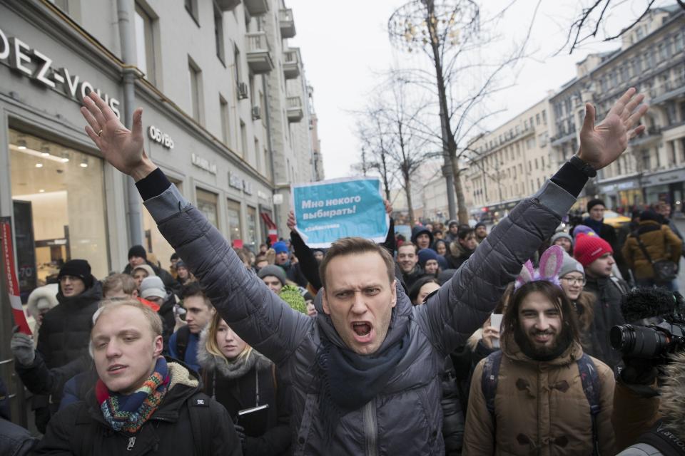 FILE - Russian opposition leader Alexei Navalny, center, attends a rally in Moscow, Russia, Sunday, Jan. 28, 2018. In a span of a decade, Navalny has gone from the Kremlin's biggest foe to Russia's most prominent political prisoner. Already serving two convictions that have landed him in prison for at least nine years, he faces a new trial that could keep him behind for another two decades. (AP Photo/Evgeny Feldman, File)