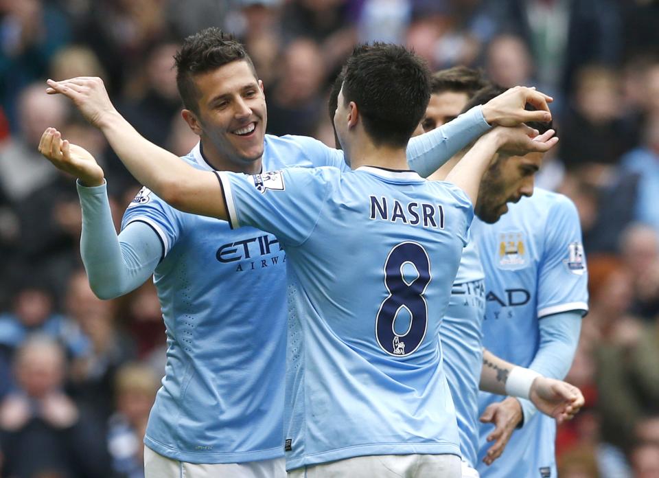 Manchester City's Stevan Jovetic (L) celebrates with team mate Samir Nasri after scoring a goal during their English Premier League soccer match against Southampton at the Etihad stadium in Manchester, northern England April 5, 2014. REUTERS/Darren Staples (BRITAIN - Tags: SPORT SOCCER) FOR EDITORIAL USE ONLY. NOT FOR SALE FOR MARKETING OR ADVERTISING CAMPAIGNS. NO USE WITH UNAUTHORIZED AUDIO, VIDEO, DATA, FIXTURE LISTS, CLUB/LEAGUE LOGOS OR "LIVE" SERVICES. ONLINE IN-MATCH USE LIMITED TO 45 IMAGES, NO VIDEO EMULATION. NO USE IN BETTING, GAMES OR SINGLE CLUB/LEAGUE/PLAYER PUBLICATIONS