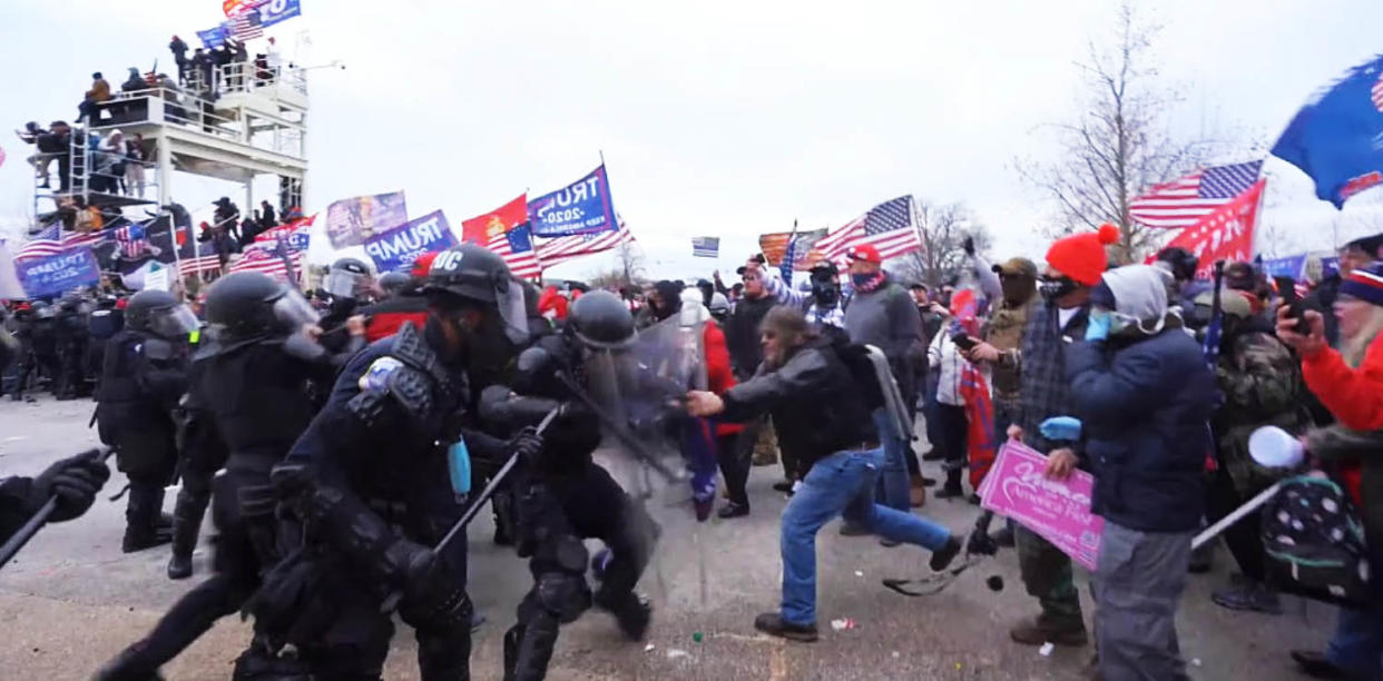 Ralph Celentano uses their riot shields against police at the Capitol on Jan. 6, 2021. (USDCDC)