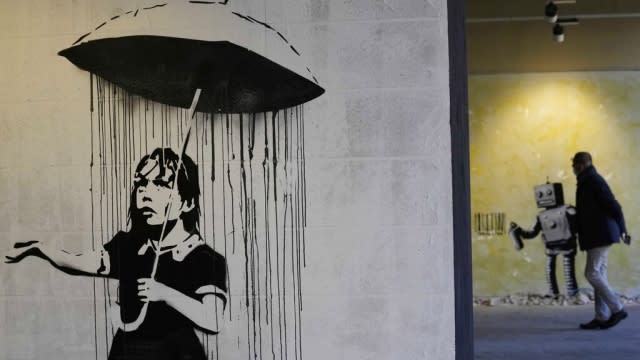 "The Umbrella girl" a reproduction of a mural by British artist Banksy.