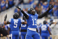 Kentucky linebacker J.J. Weaver blows kisses to Louisville fans after getting a stop against Louisville during the first half of an NCAA college football game in Lexington, Ky., Saturday, Nov. 26, 2022. (AP Photo/Michael Clubb)