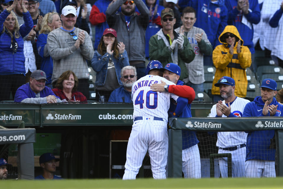 Chicago Cubs' Willson Contreras (40) gets a hug from manager David Ross at the dugout after coming out of a baseball game after walking during the eighth inning of a baseball game against the Cincinnati Reds, Sunday, Oct. 2, 2022, in Chicago. (AP Photo/Paul Beaty)